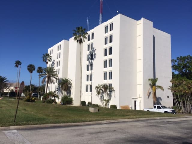Exterior of Roberts Hall at Florida Institute of Technology in Melbourne, Florida, a seven-story white building with radio antennas on the roof.